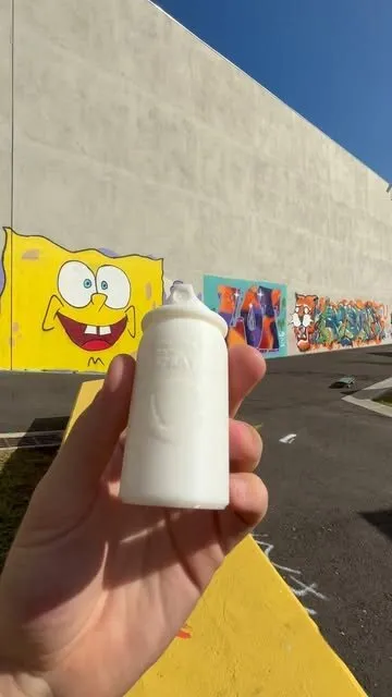 Video still: a white plastic 3D-printed piece held in a hand